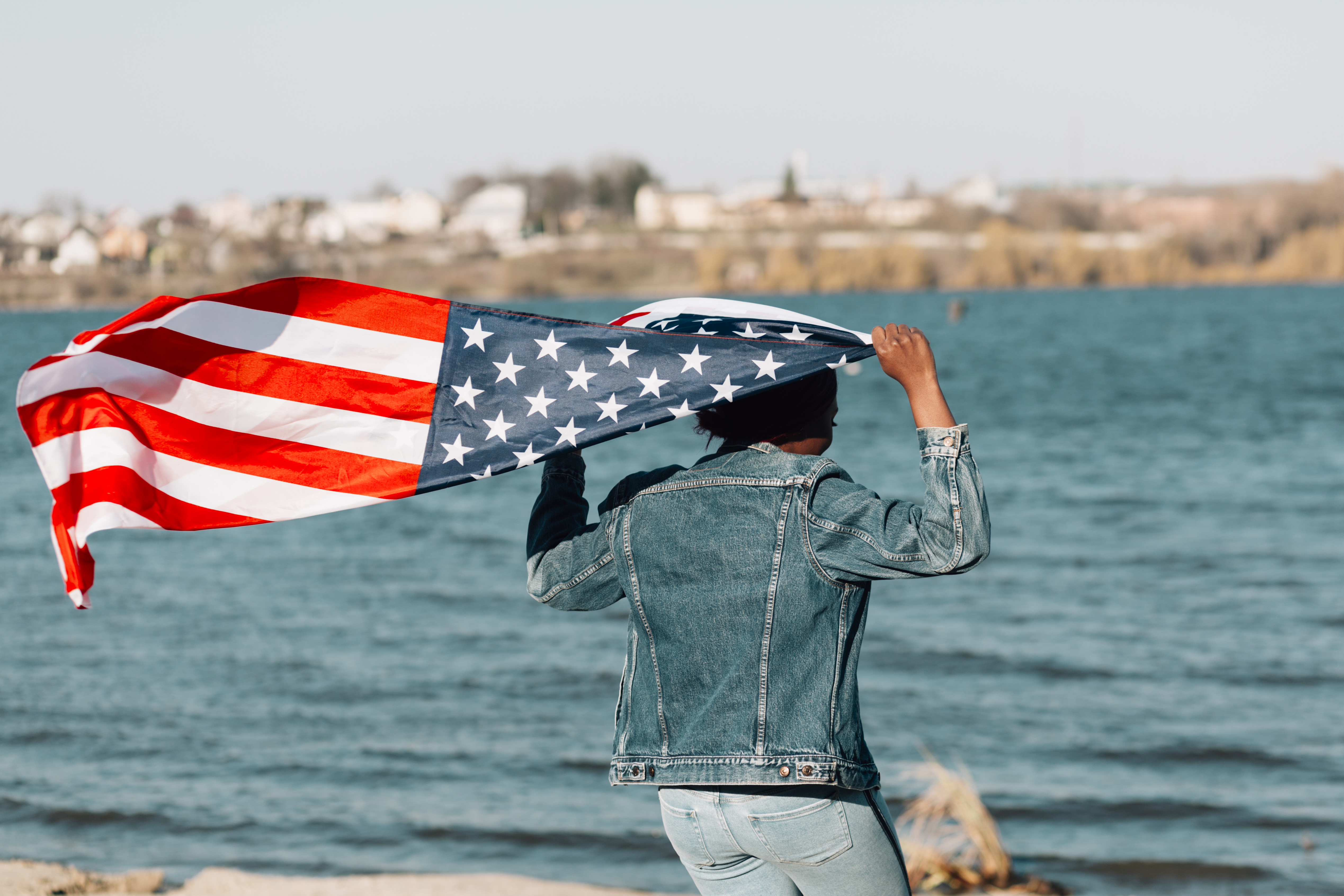 woman waving USA flag in Portugal